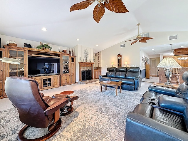 living room featuring lofted ceiling, light tile patterned floors, a fireplace with raised hearth, and visible vents