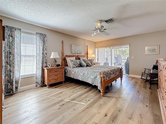 bedroom with access to exterior, visible vents, baseboards, ceiling fan, and light wood-type flooring