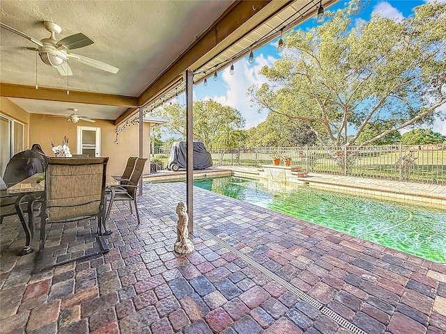 view of pool featuring a fenced in pool, a fenced backyard, a patio area, outdoor dining space, and a ceiling fan