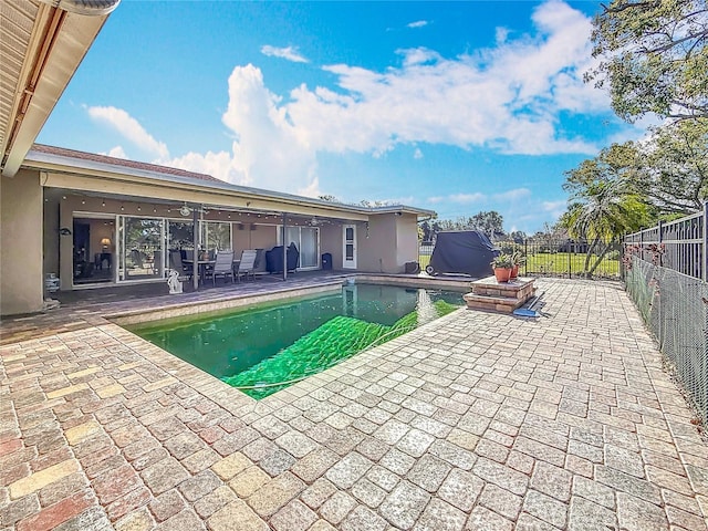 view of swimming pool with a fenced in pool, a patio area, and fence