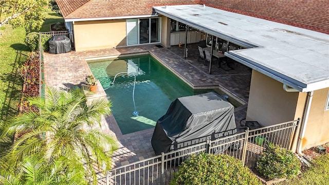 view of swimming pool with a fenced in pool, a patio, and fence