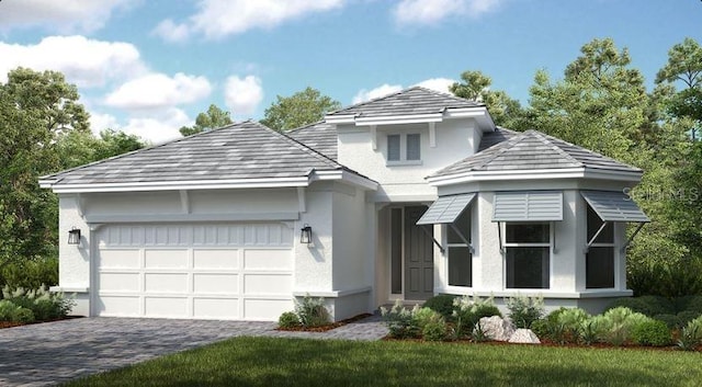 view of front facade featuring decorative driveway, a garage, and stucco siding