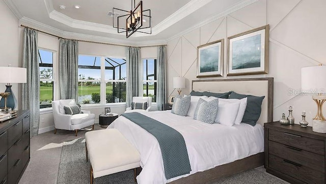 carpeted bedroom featuring a raised ceiling, a chandelier, and crown molding