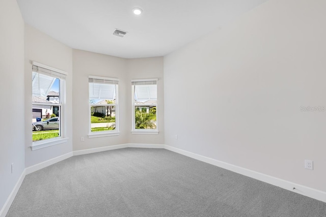 unfurnished room featuring recessed lighting, carpet, visible vents, and baseboards