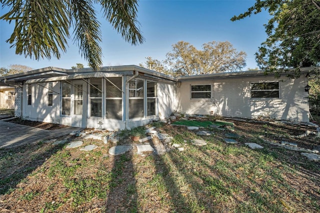 back of house with a sunroom