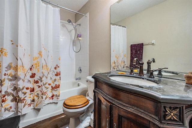 bathroom with toilet, shower / bath combo, a textured ceiling, wood finished floors, and vanity