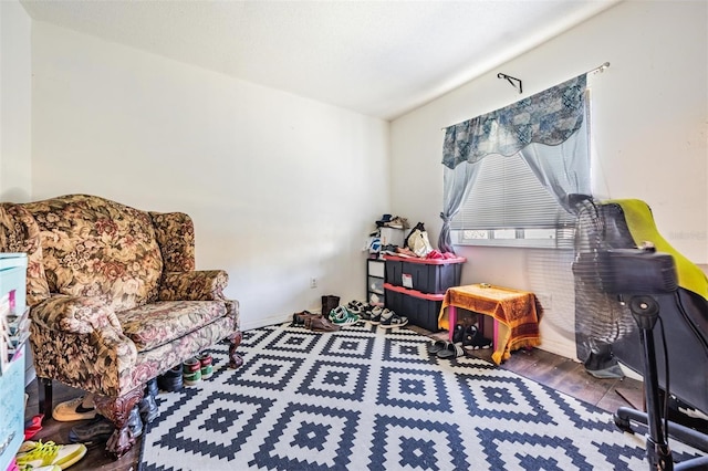 interior space with baseboards and wood finished floors