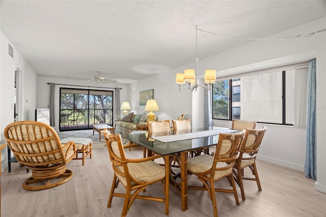 dining area featuring a textured ceiling, visible vents, light wood-type flooring, and baseboards