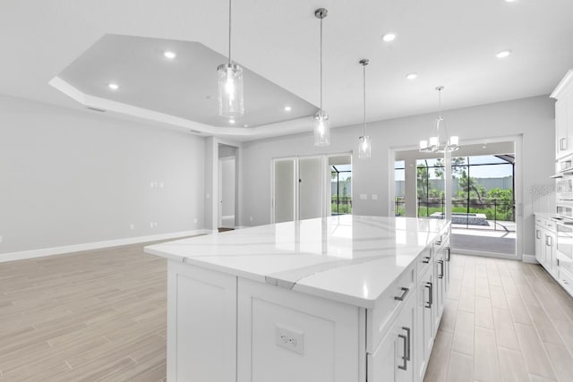 3563 Santa Caterina Blvd, Bradenton, FL 34211 - kitchen featuring light wood-style flooring, recessed lighting, white cabinetry, and a kitchen island