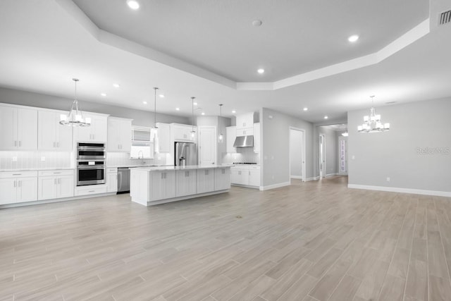 3563 Santa Caterina Blvd, Bradenton, FL 34211 - kitchen featuring a chandelier, under cabinet range hood, open floor plan, and stainless steel appliances