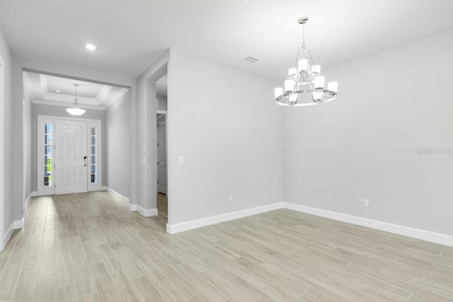 3563 Santa Caterina Blvd, Bradenton, FL 34211 - foyer entrance featuring light wood finished floors, crown molding, baseboards, and an inviting chandelier