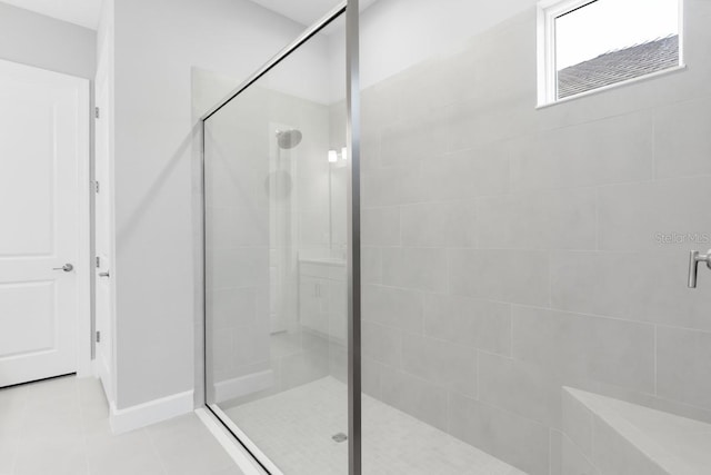 3563 Santa Caterina Blvd, Bradenton, FL 34211 - bathroom featuring a shower stall, tile patterned flooring, and baseboards