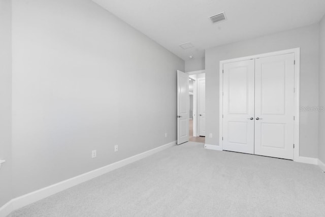 3563 Santa Caterina Blvd, Bradenton, FL 34211 - unfurnished bedroom with light carpet, a closet, visible vents, and baseboards