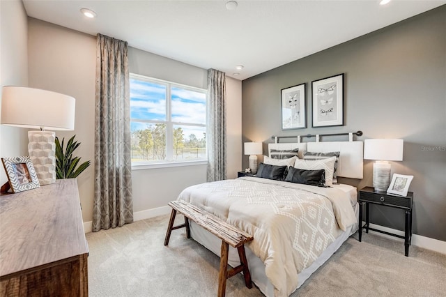 bedroom with recessed lighting, light colored carpet, and baseboards