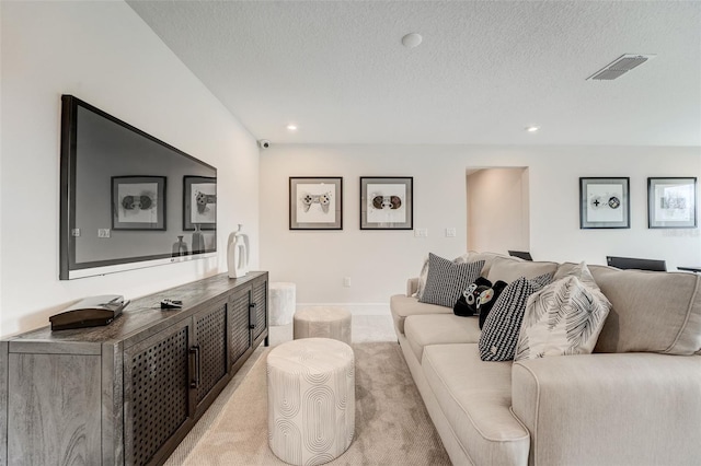 living room featuring visible vents, baseboards, light carpet, recessed lighting, and a textured ceiling