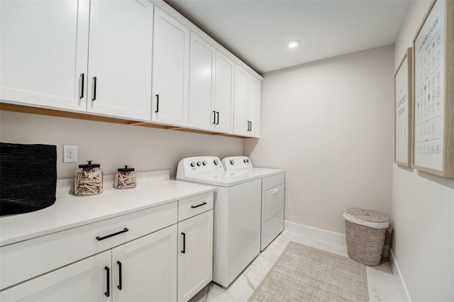 laundry area featuring baseboards, recessed lighting, cabinet space, marble finish floor, and independent washer and dryer