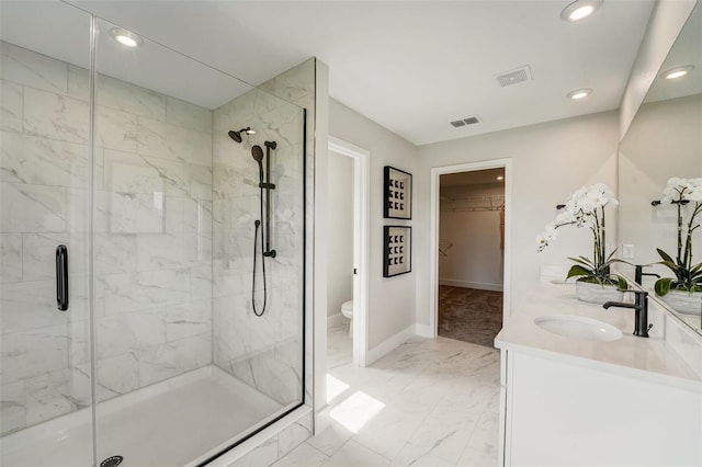 bathroom with visible vents, marble finish floor, a stall shower, and a sink