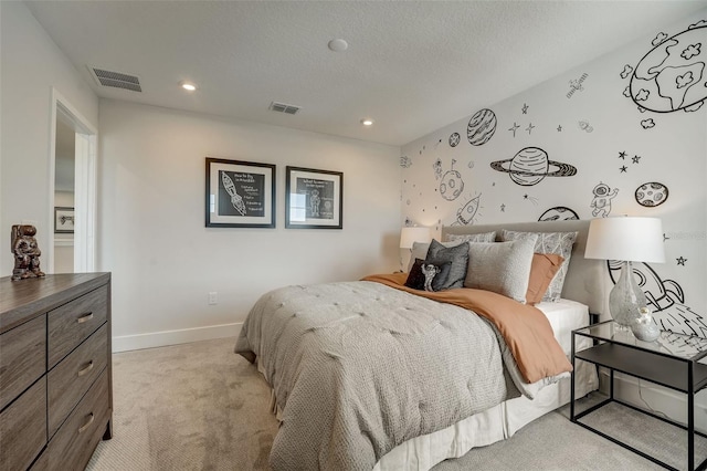 bedroom with light carpet, visible vents, a textured ceiling, and baseboards