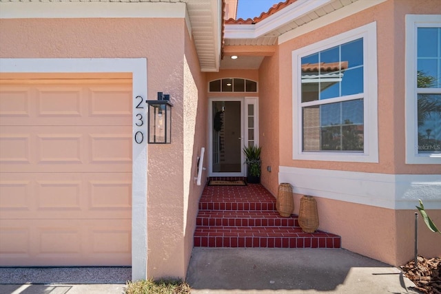 property entrance featuring stucco siding and a tile roof