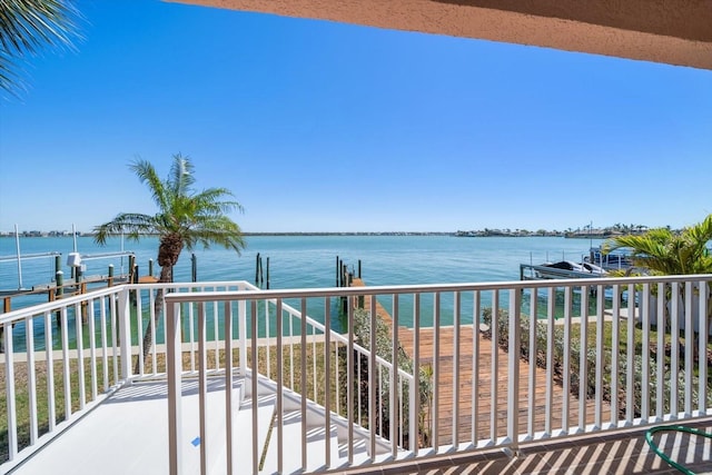 balcony with a dock and a water view