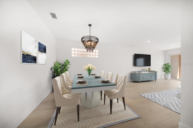 dining area with visible vents, recessed lighting, an inviting chandelier, and wood finished floors