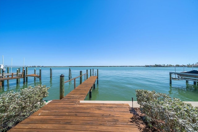 view of dock with boat lift and a water view