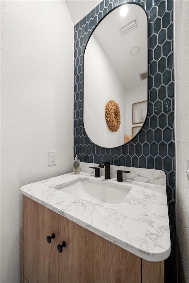 bathroom featuring vanity and visible vents