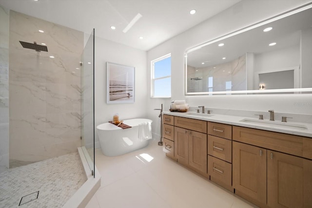 bathroom featuring a marble finish shower, a soaking tub, double vanity, and a sink