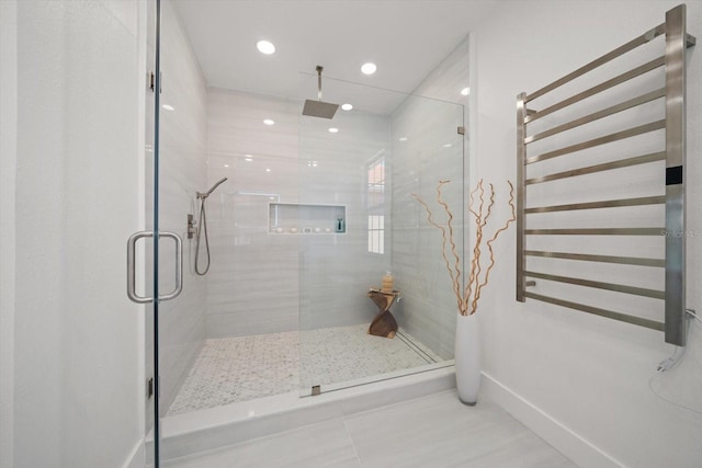 bathroom featuring recessed lighting, radiator, a stall shower, and baseboards