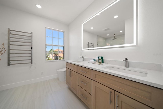 full bathroom with a sink, baseboards, toilet, and radiator heating unit