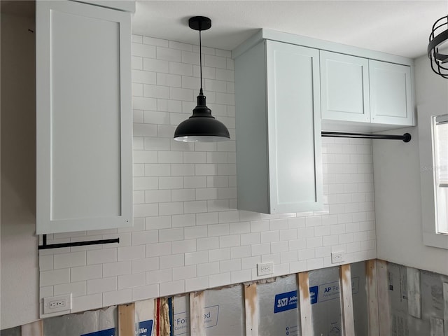 interior details featuring white cabinets and decorative light fixtures