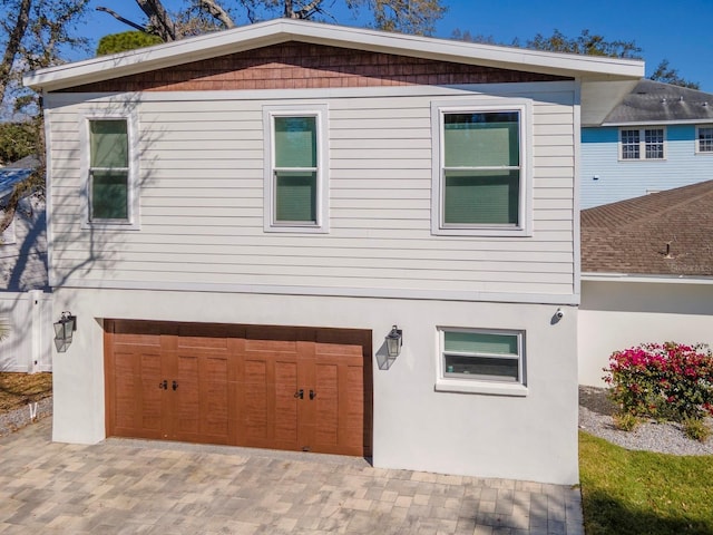 exterior space with stucco siding and a garage