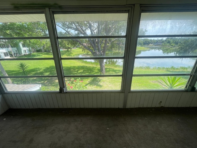 unfurnished sunroom with a water view