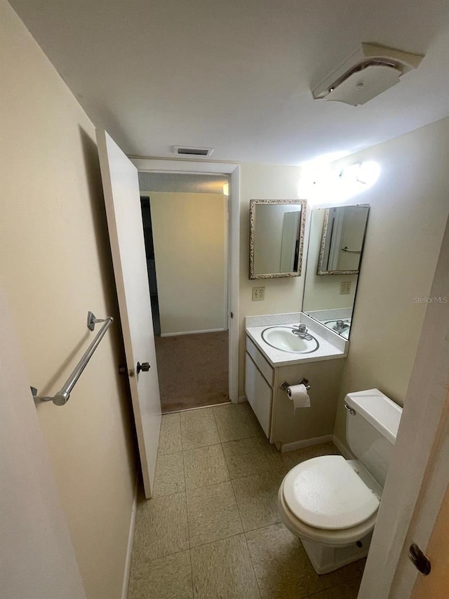 bathroom with visible vents, toilet, and vanity