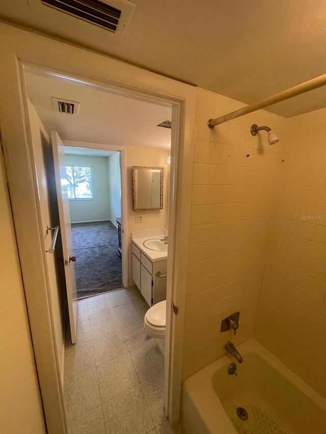 full bath featuring visible vents, toilet, vanity, and shower / tub combination