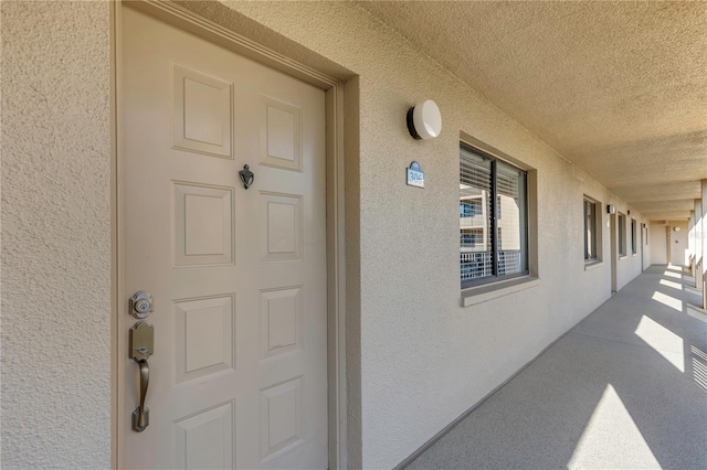 view of exterior entry with stucco siding