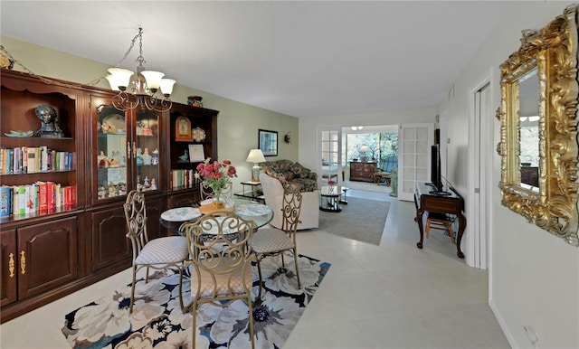 dining area featuring an inviting chandelier and baseboards