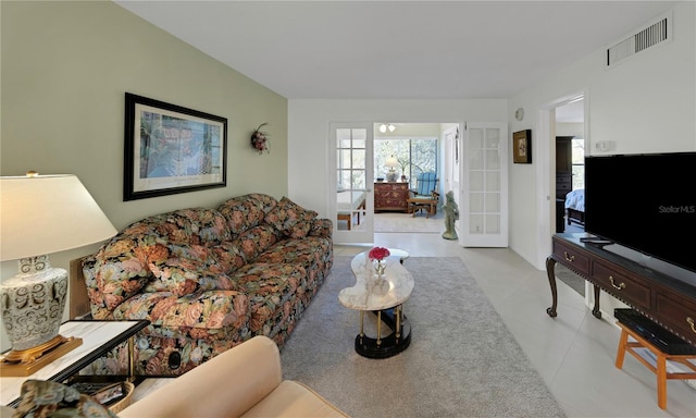 living area featuring french doors and visible vents