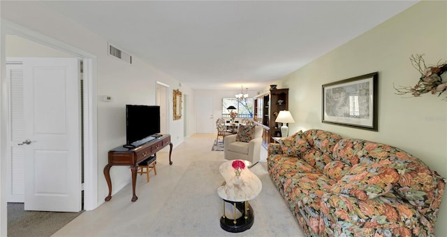 living area with visible vents and a notable chandelier