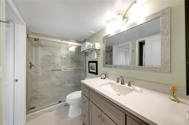 full bathroom with a marble finish shower, toilet, a closet, and vanity