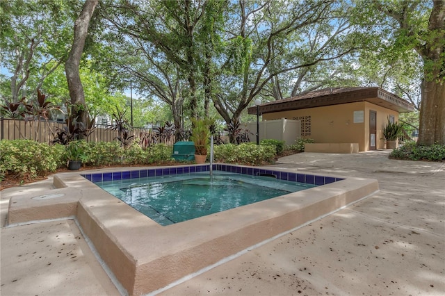 view of pool featuring a swimming pool, a patio, an outbuilding, and a fenced backyard