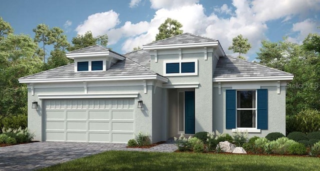 prairie-style home featuring decorative driveway, a garage, and stucco siding