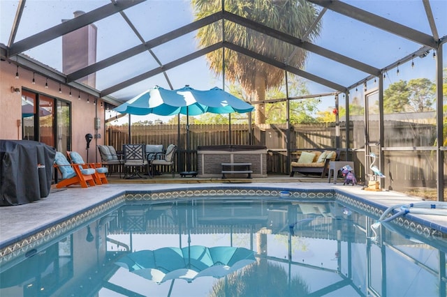 view of swimming pool with a lanai, a fenced backyard, a fenced in pool, and a patio area