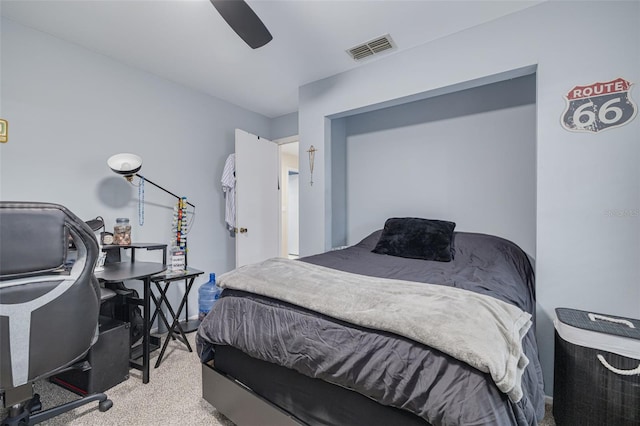 carpeted bedroom featuring a ceiling fan and visible vents