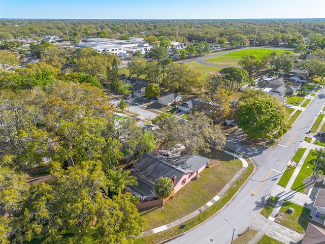 drone / aerial view with a residential view and a wooded view