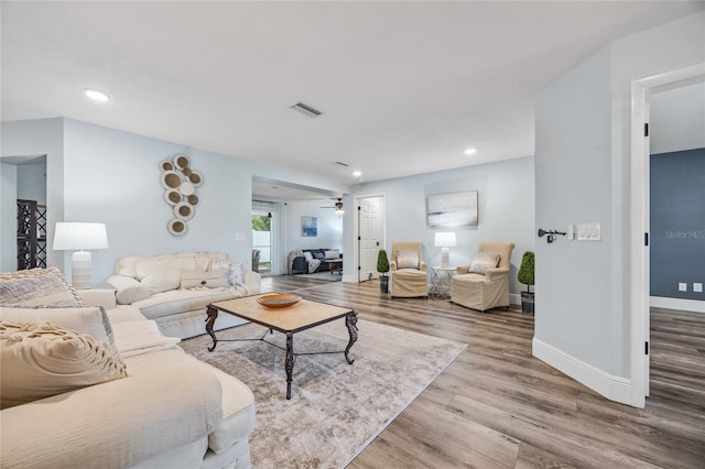 living area with visible vents, ceiling fan, baseboards, recessed lighting, and wood finished floors