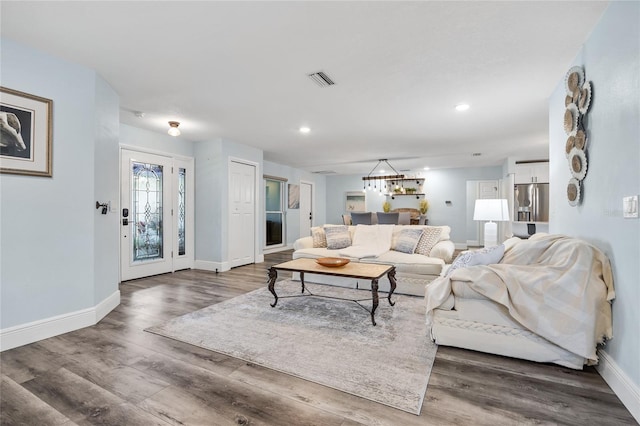 living area with recessed lighting, wood finished floors, and baseboards