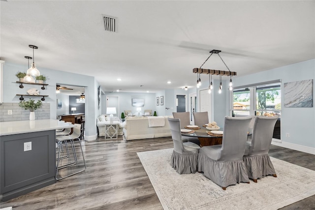 dining room featuring recessed lighting, dark wood-style floors, visible vents, and baseboards