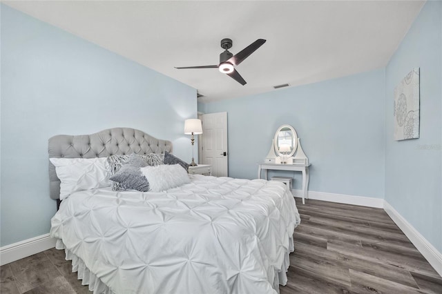 bedroom with visible vents, ceiling fan, baseboards, and wood finished floors