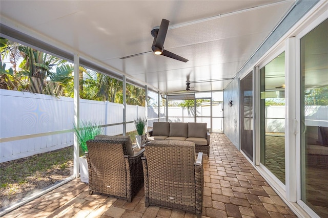 sunroom featuring a ceiling fan